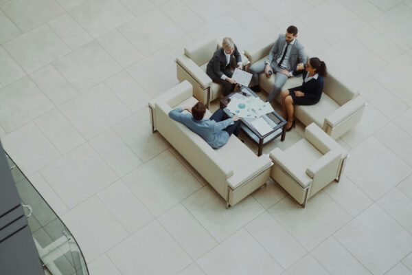 Aerial view of a group business meeting in a modern office setting.